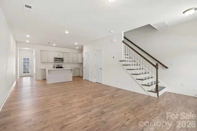 a view of a kitchen with furniture and stairs