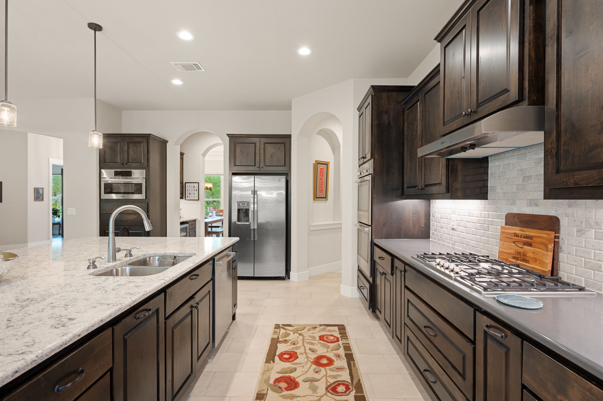 212 Marbella Way Georgetown, TX 78633 - Photo 12 of 40 a kitchen with stainless steel appliances granite countertop a sink stove and refrigerator