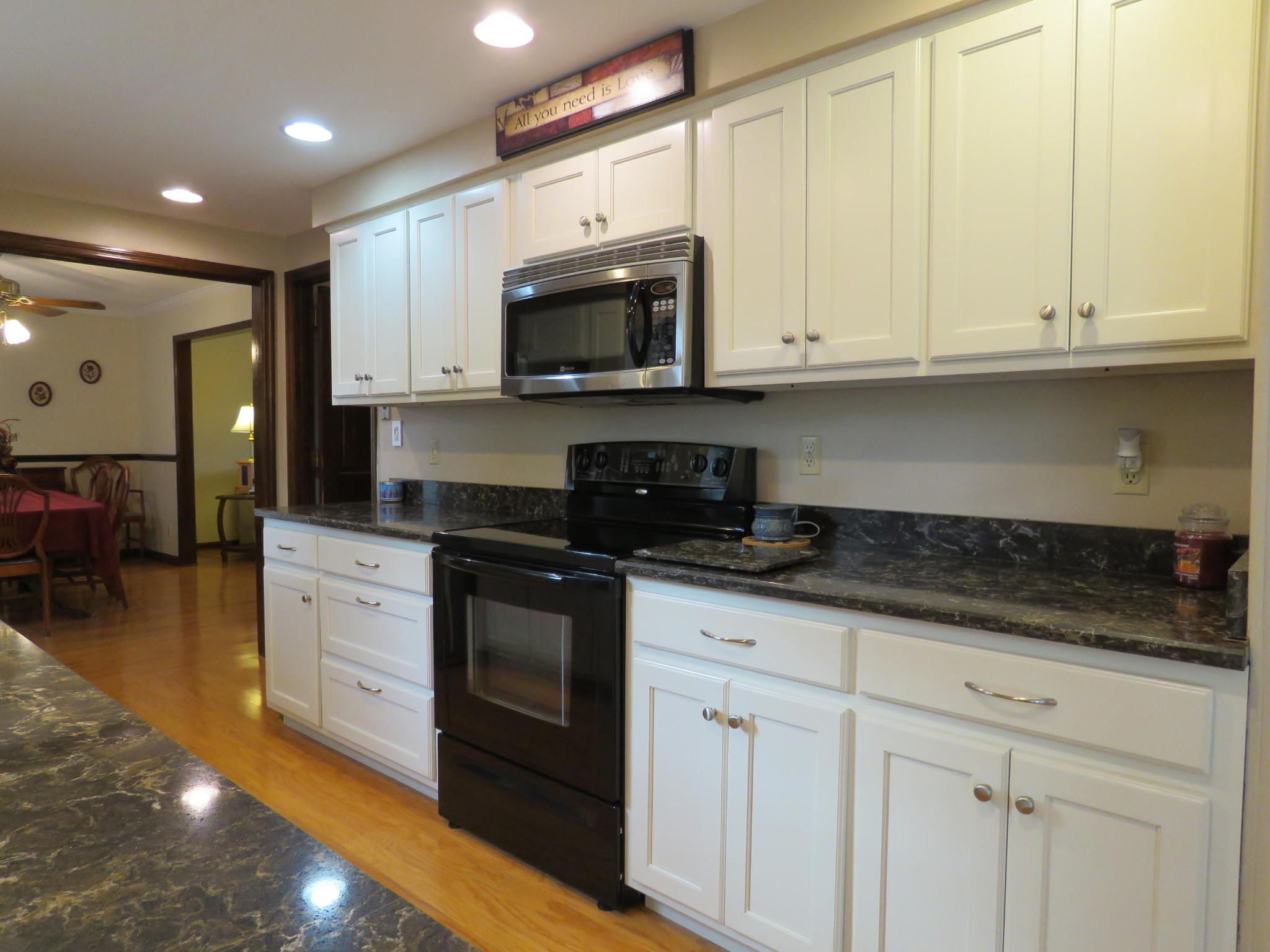 18 Clark Place Oak Ridge, TN 37830 - Photo 6 of 20 a kitchen with stainless steel appliances granite countertop white cabinets granite counter tops and a hard wood floors