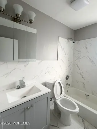 a bathroom with a sink toilet and shower