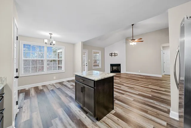 an empty room with closet and windows