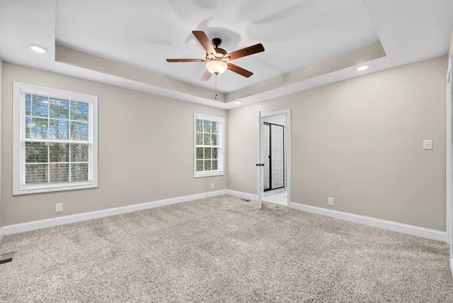 an empty room with closet and ceiling fan