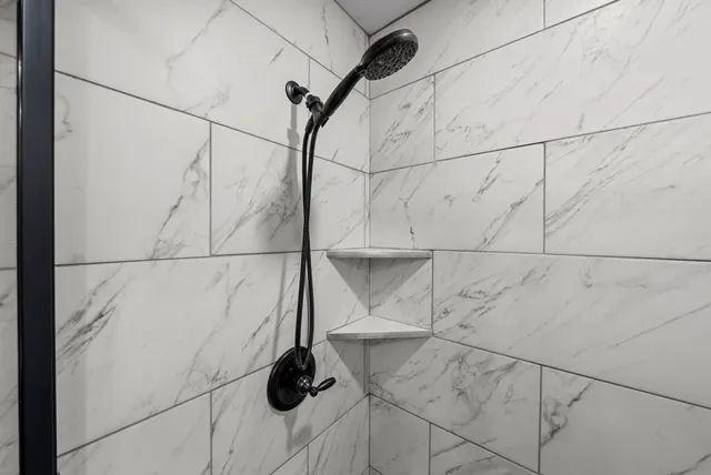 a view of room with walk in closet and wooden floor