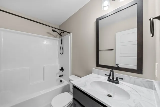 an empty room with window and ceiling fan