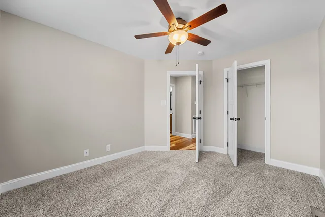 a bathroom with a granite countertop shower a mirror and a sink