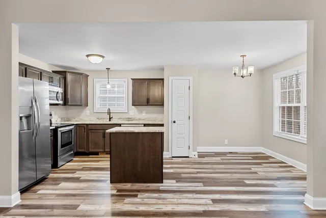 a kitchen with a refrigerator stove and microwave