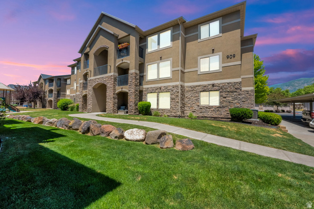 909 South Main Street, Unit G Layton, UT 84041 - Photo 25 of 25 Multi-story building featuring a stucco exterior with stone veneer accents, multiple balconies, and visible unit numbers