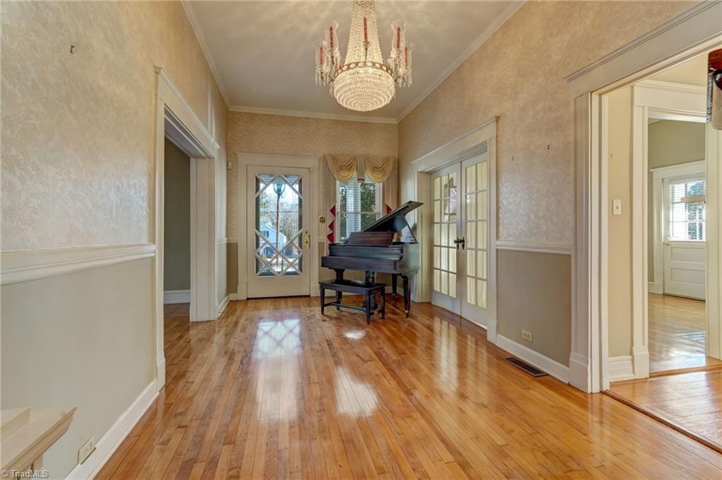521 Patrick Street Eden, NC 27288 - Photo 4 of 50 Entrance foyer with chandelier and baby grand piano that goes with house if you want it
