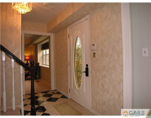 25 Tripplet Road Somerset, NJ 08873 - Photo 2 of 10 a view of a hallway with wooden floor and a bathroom