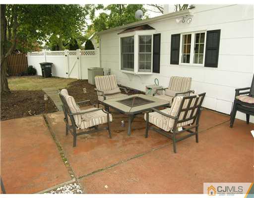 25 Tripplet Road Somerset, NJ 08873 - Photo 9 of 10 a view of a patio with a table and chairs