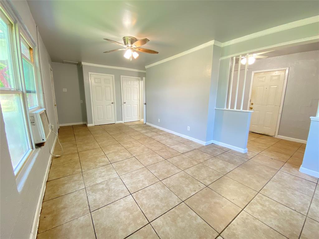 1203 Hall Street Lancaster, TX 75146 - Photo 5 of 11 a view of an empty room with a chandelier fan