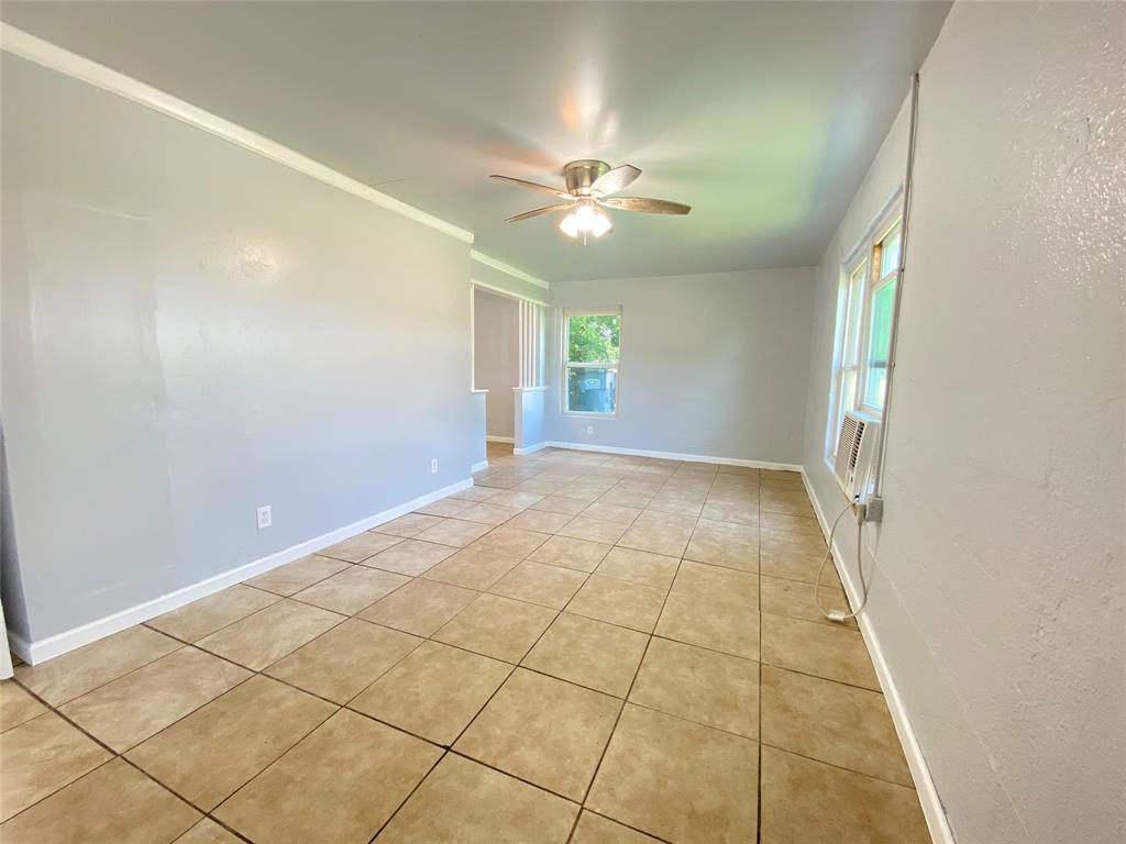 1203 Hall Street Lancaster, TX 75146 - Photo 6 of 11 en empty room with windows and ceiling fan
