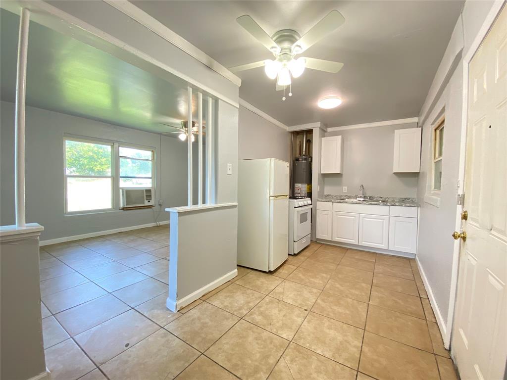 1203 Hall Street Lancaster, TX 75146 - Photo 7 of 11 a view of a kitchen with a sink cabinets and window