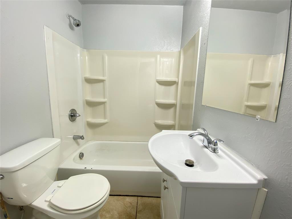 1203 Hall Street Lancaster, TX 75146 - Photo 10 of 11 a bathroom with a sink toilet and shower