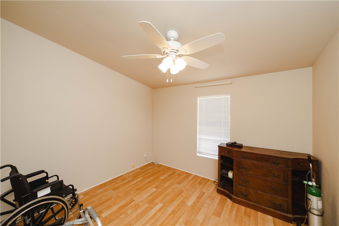 4729 Stewart Mountain Road Golden Valley, AZ 86413 - Photo 18 of 28 a bedroom with a bed and a ceiling fan