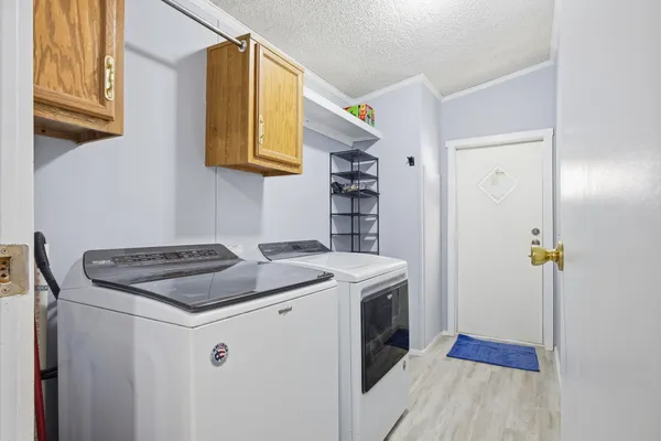 a kitchen with stainless steel appliances granite countertop a sink and a refrigerator