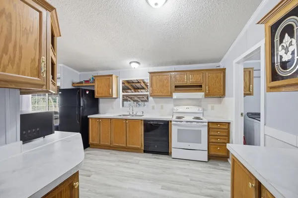 a kitchen with stainless steel appliances granite countertop a stove and cabinets
