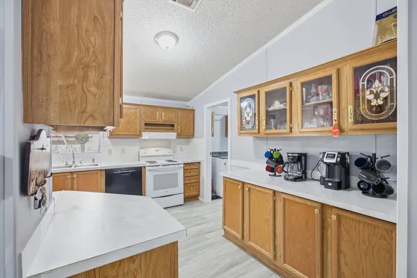 a kitchen with stainless steel appliances granite countertop a sink and cabinets