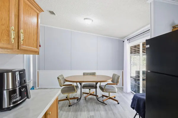a dining room with furniture and wooden floor
