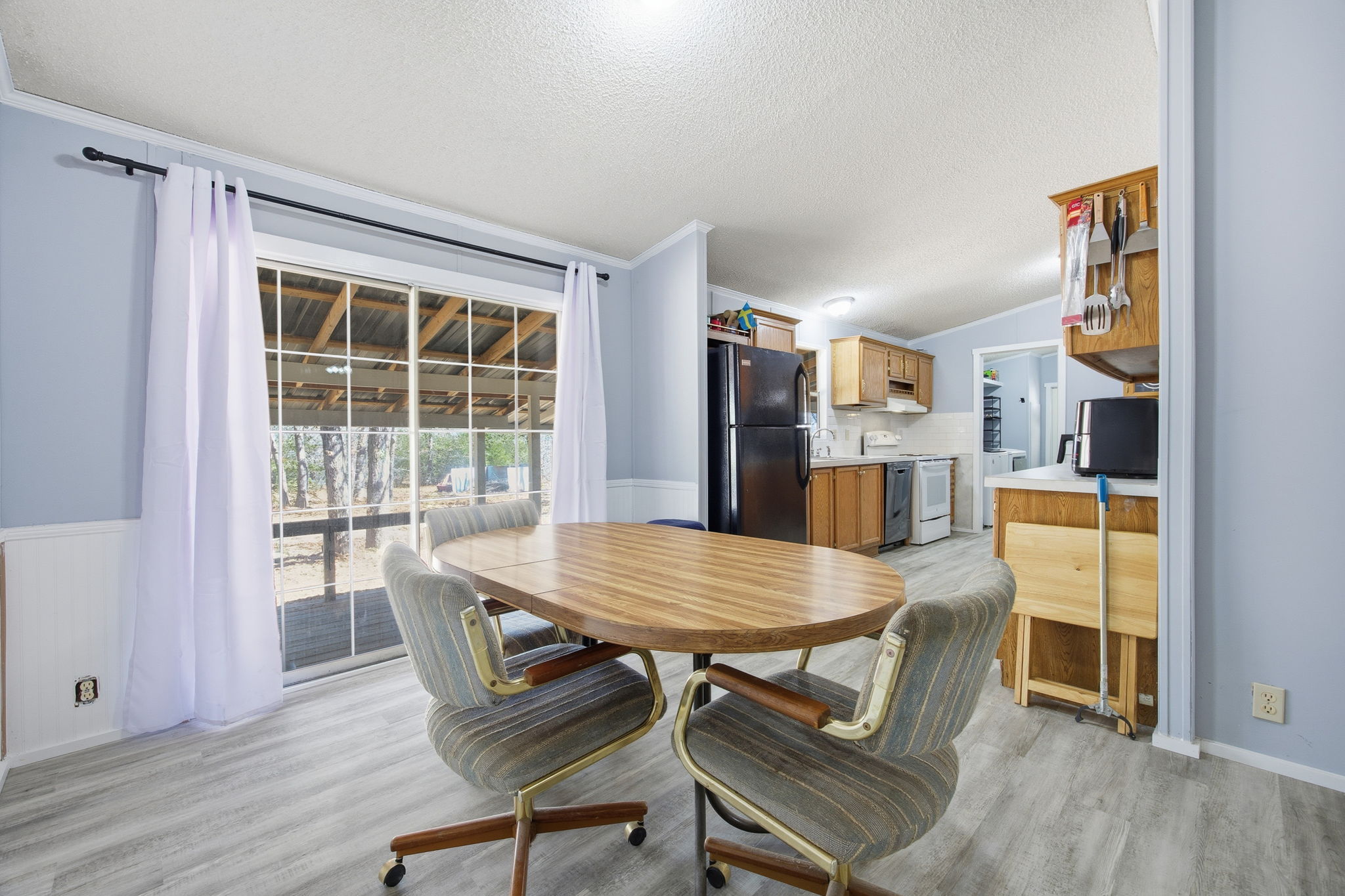182 Wayside Court Elgin, TX 78621 - Photo 18 of 40 Dining room featuring light wood-style flooring and a textured ceiling