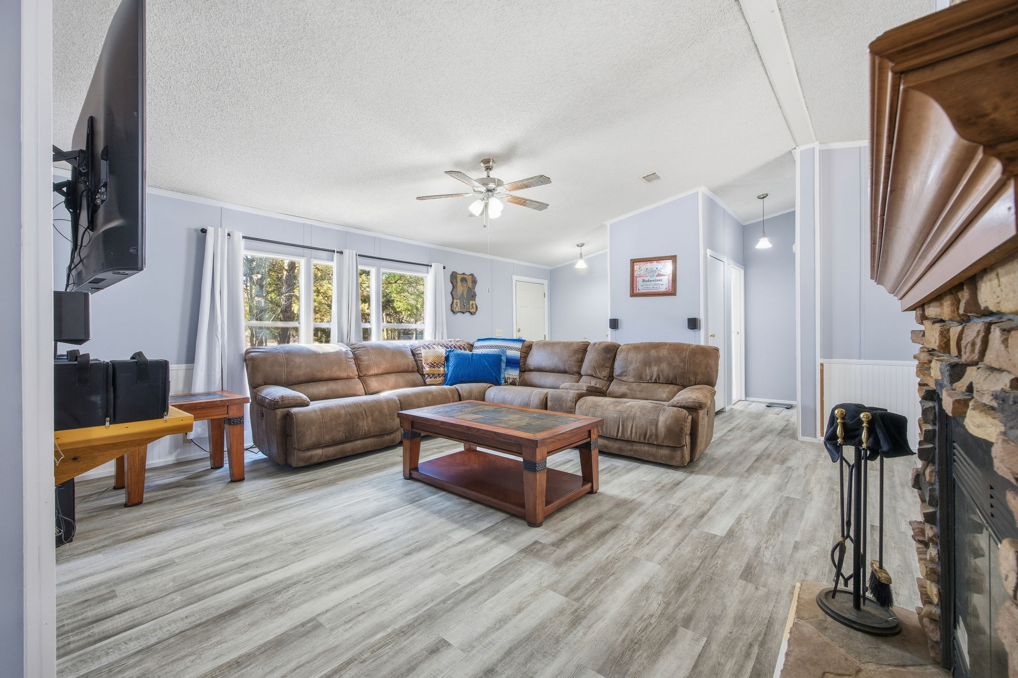 182 Wayside Court Elgin, TX 78621 - Photo 20 of 40 Living room featuring a fireplace, ceiling fan, light wood-style flooring, and ornamental molding