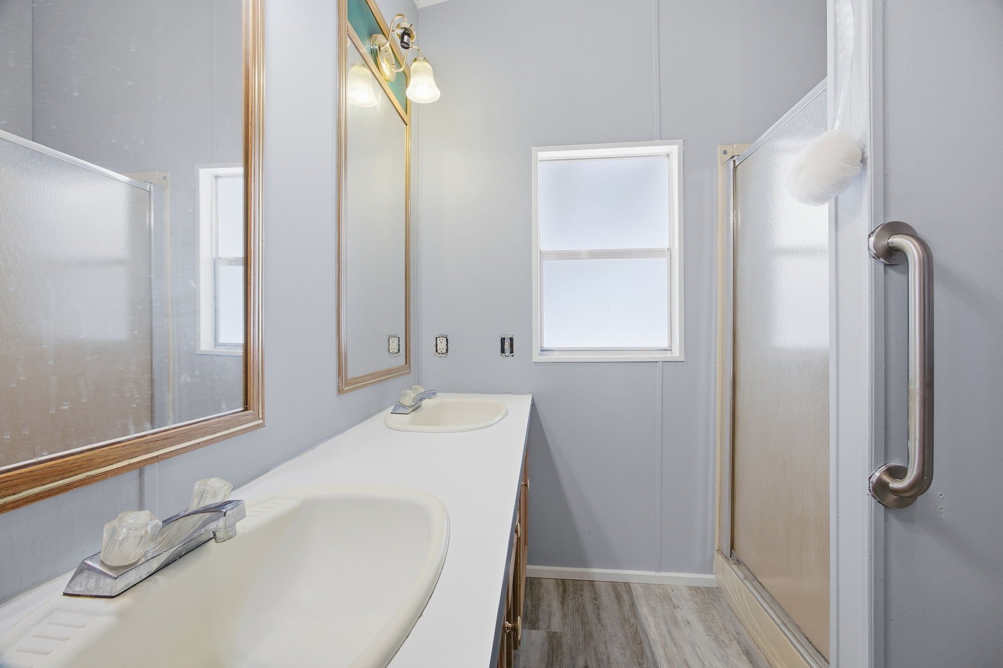 182 Wayside Court Elgin, TX 78621 - Photo 25 of 40 Full bathroom featuring double vanity, a stall shower, and light wood-style flooring