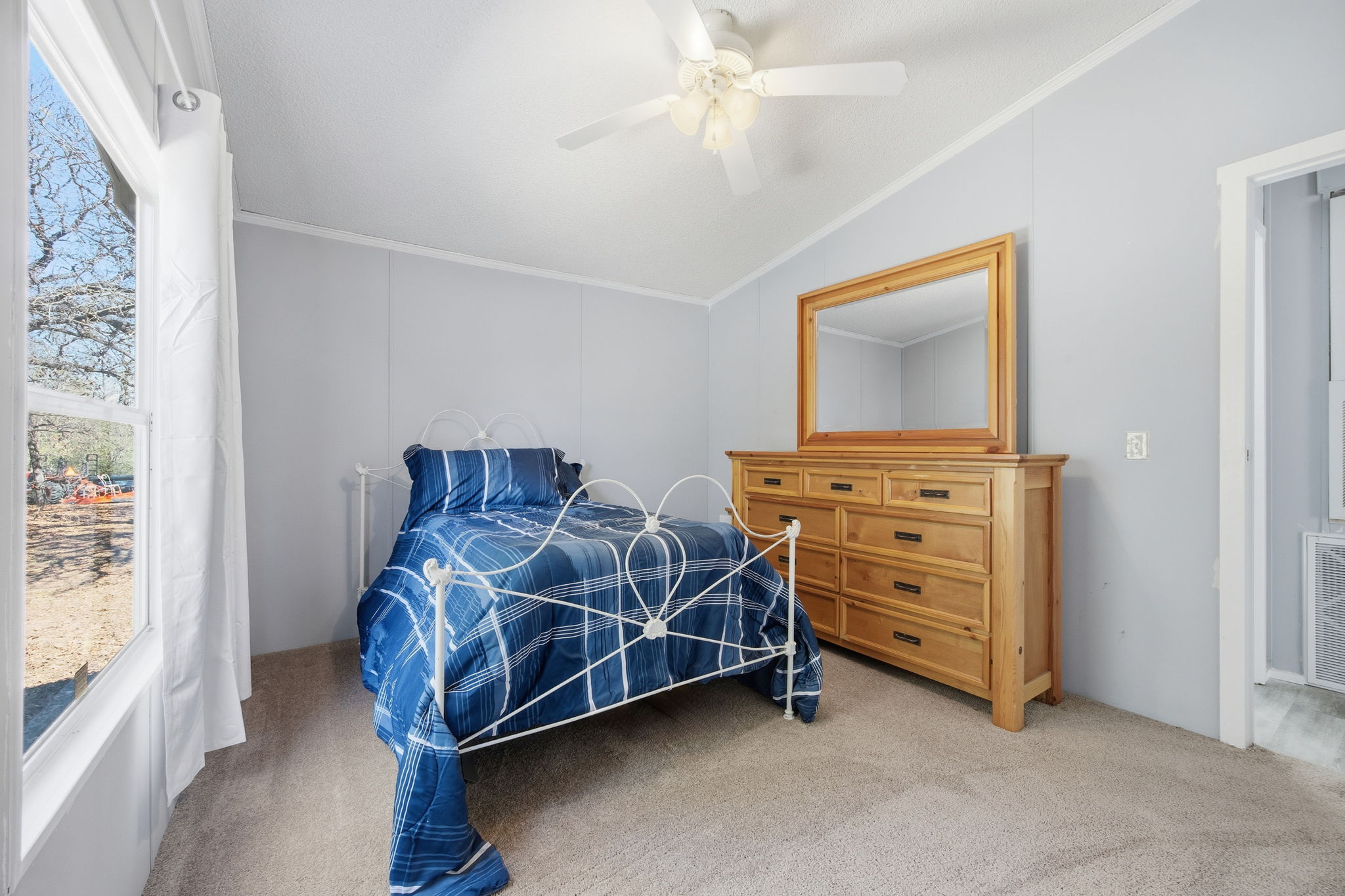 182 Wayside Court Elgin, TX 78621 - Photo 27 of 40 Carpeted bedroom with vaulted ceiling, ceiling fan, and ornamental molding