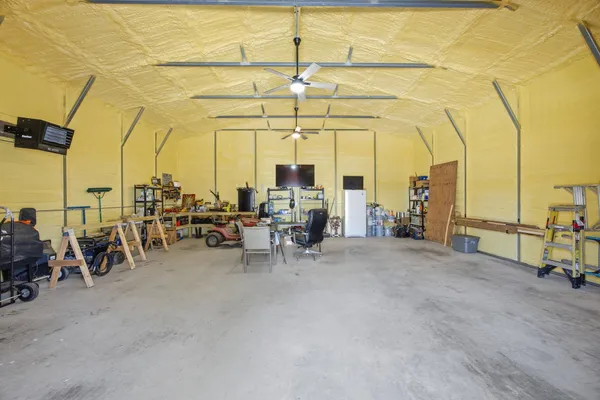 a view of a house with backyard and wooden fence