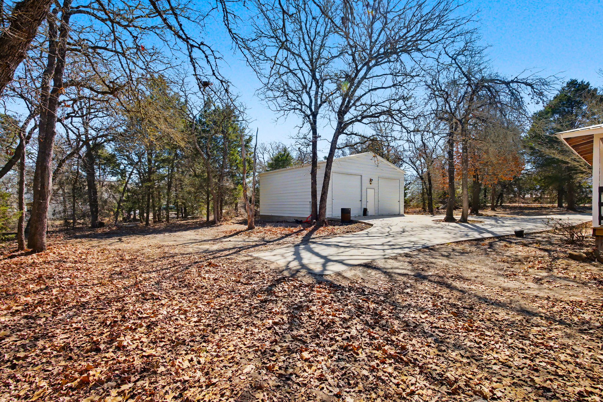 182 Wayside Court Elgin, TX 78621 - Photo 38 of 40 View of yard with a detached garage and an outdoor structure