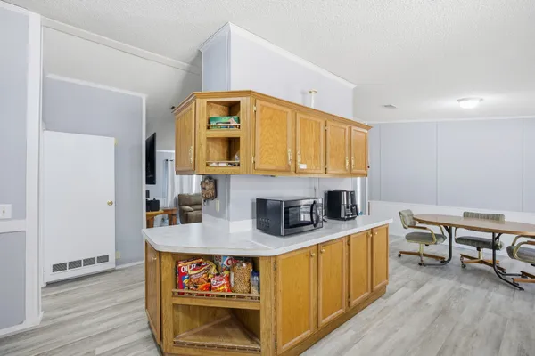 a kitchen with stainless steel appliances granite countertop a sink stove refrigerator and cabinets