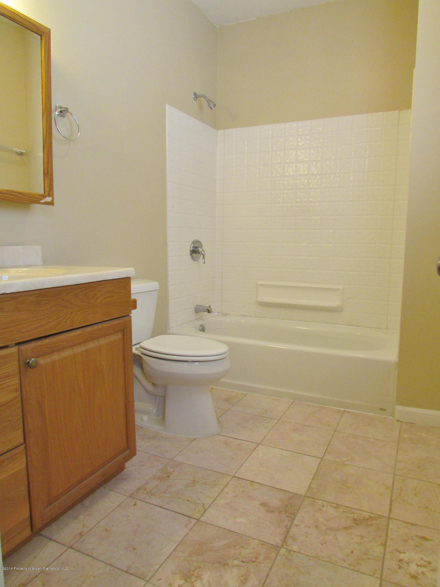 1318 East 7th Street Rifle, CO 81650 - Photo 11 of 19 a bathroom with a toilet a sink and mirror