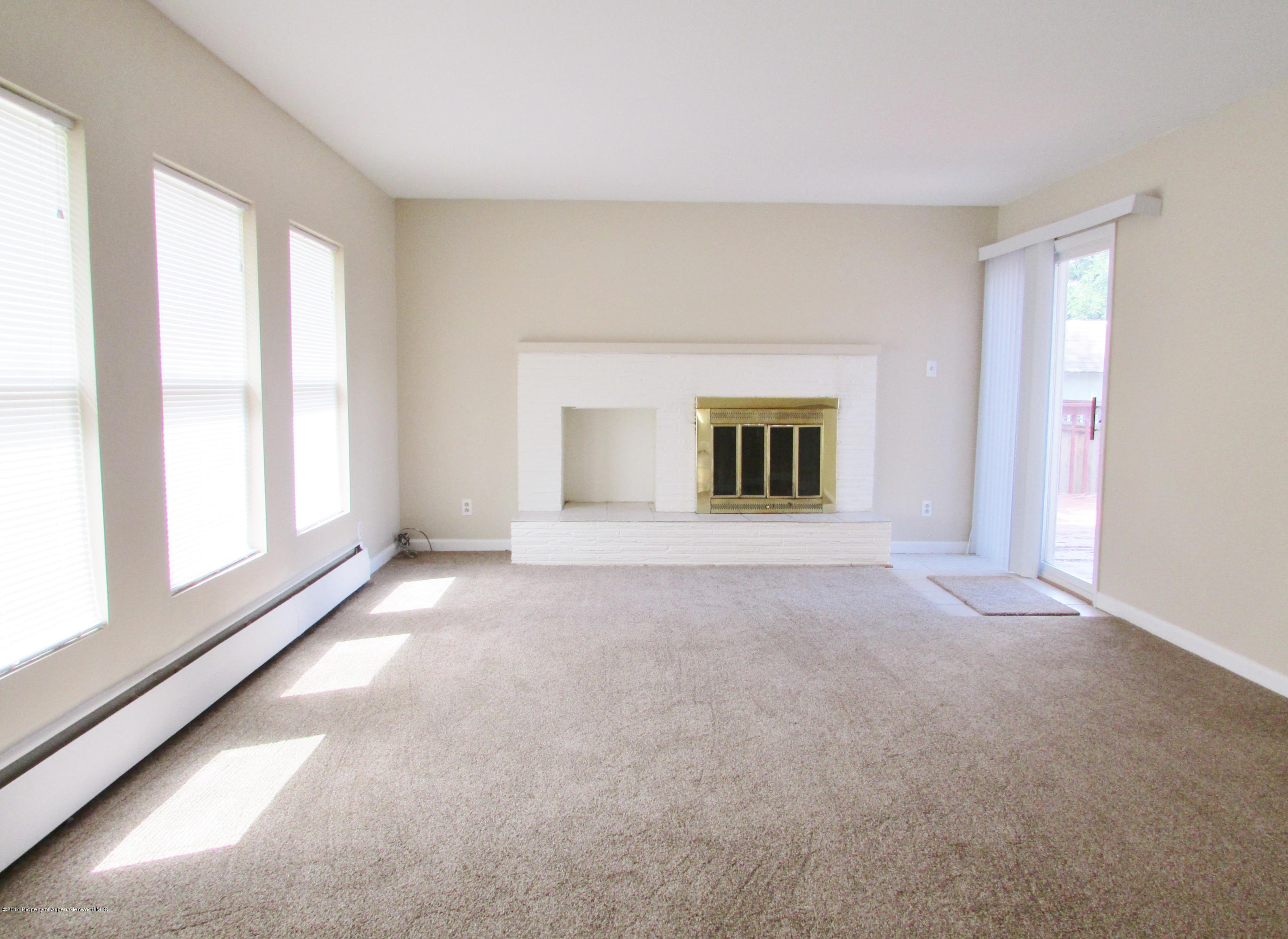 1318 East 7th Street Rifle, CO 81650 - Photo 4 of 19 a view of a big room with windows and chandelier fan