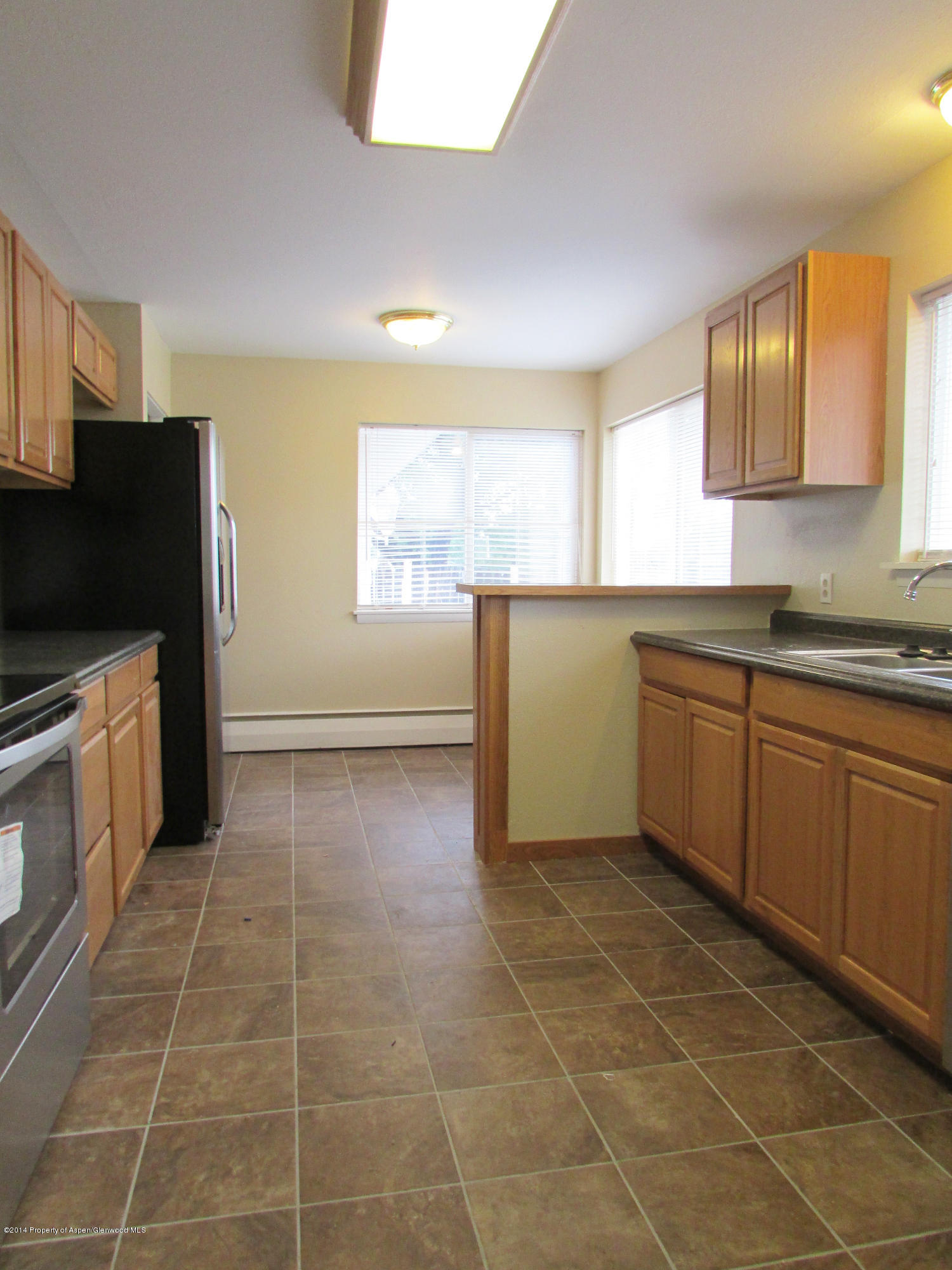 1318 East 7th Street Rifle, CO 81650 - Photo 5 of 19 a kitchen with a sink a stove cabinets and counter space