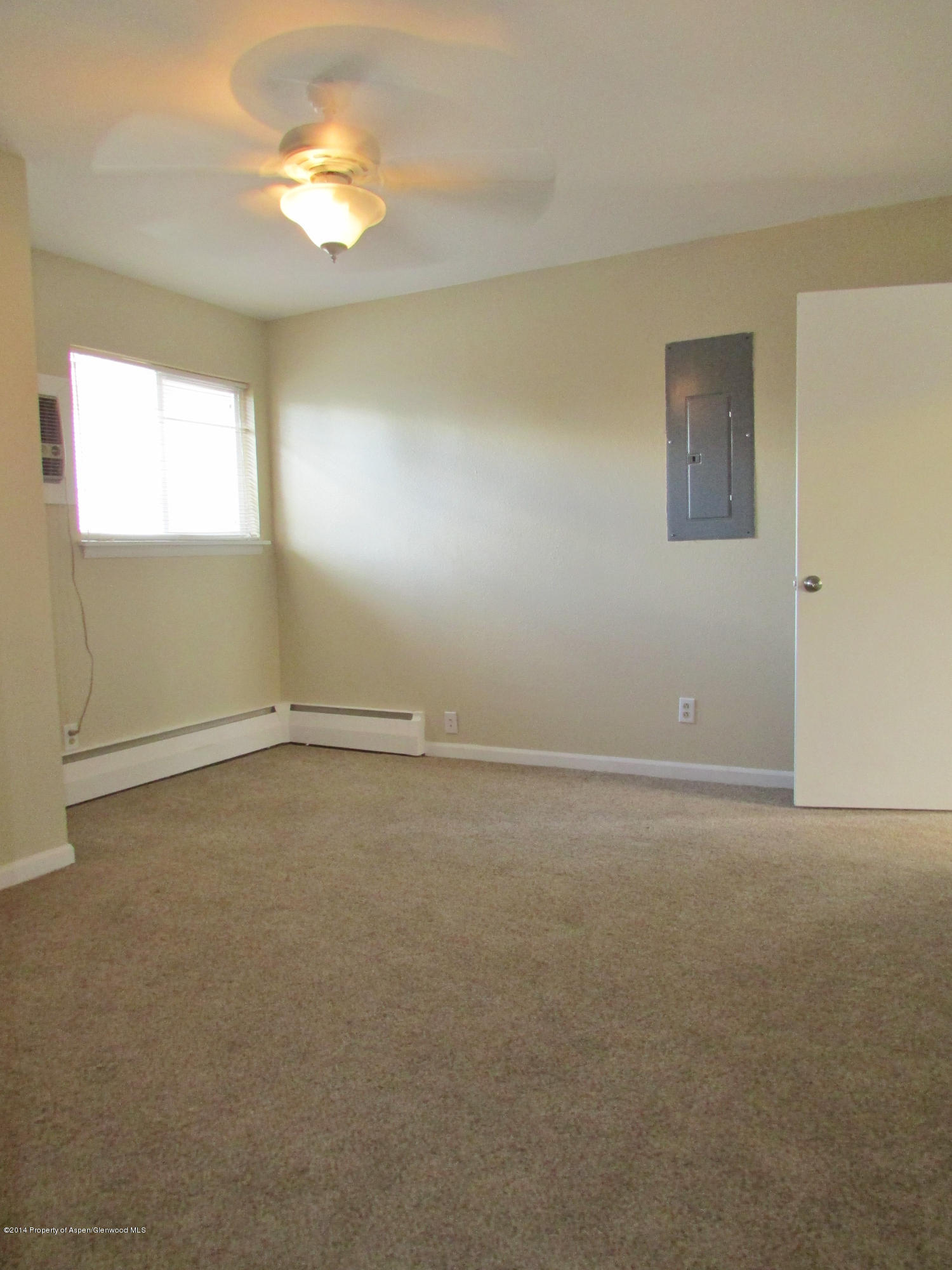 1318 East 7th Street Rifle, CO 81650 - Photo 8 of 19 a view of an empty room with a window