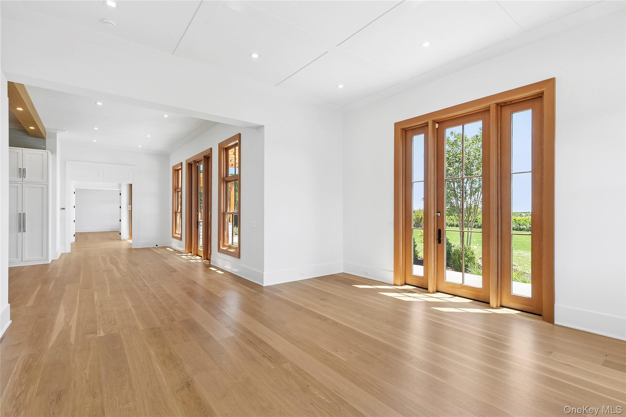 522 Wickapogue Road Southampton, NY 11968 - Photo 17 of 49 a view of an empty room with wooden floor and a window