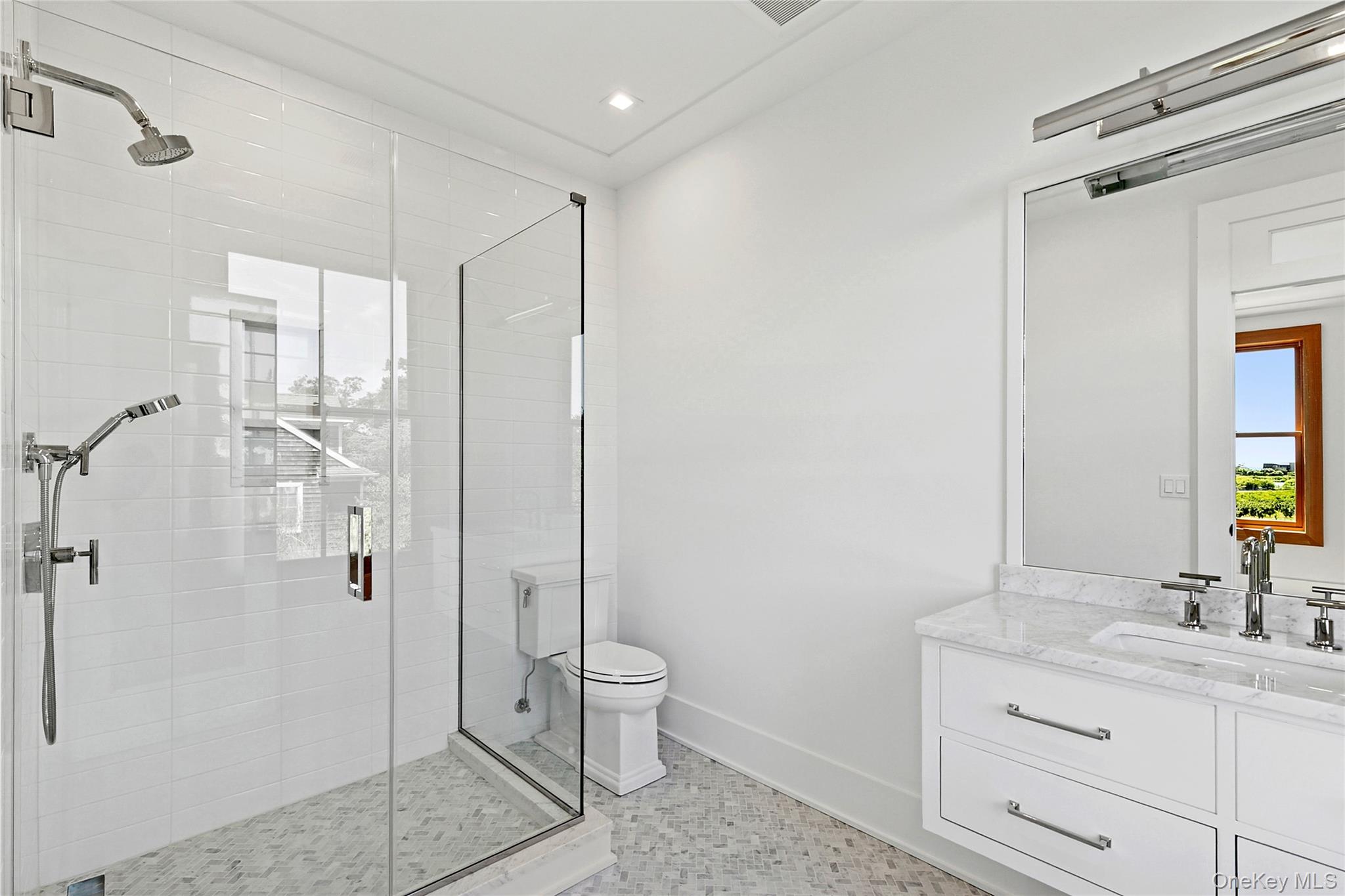 522 Wickapogue Road Southampton, NY 11968 - Photo 25 of 49 a bathroom with a double vanity sink toilet and shower