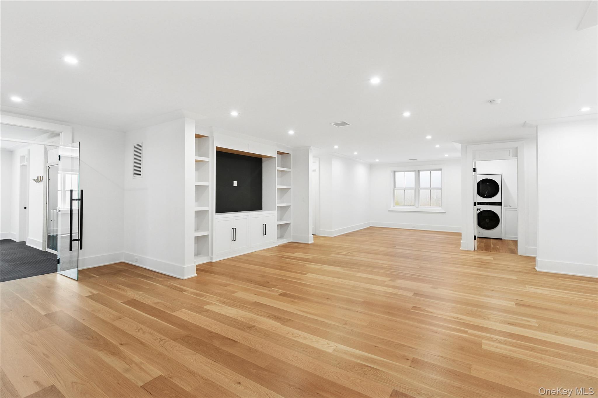 522 Wickapogue Road Southampton, NY 11968 - Photo 35 of 49 a view of an empty room with wooden floor and windows