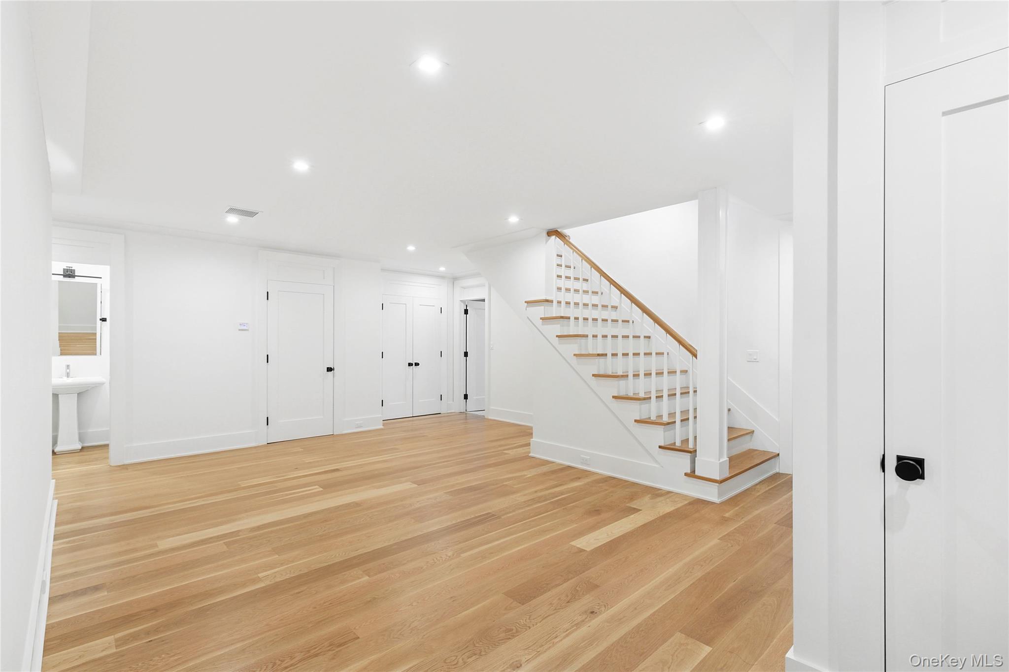 522 Wickapogue Road Southampton, NY 11968 - Photo 41 of 49 a view of an empty room with wooden floor