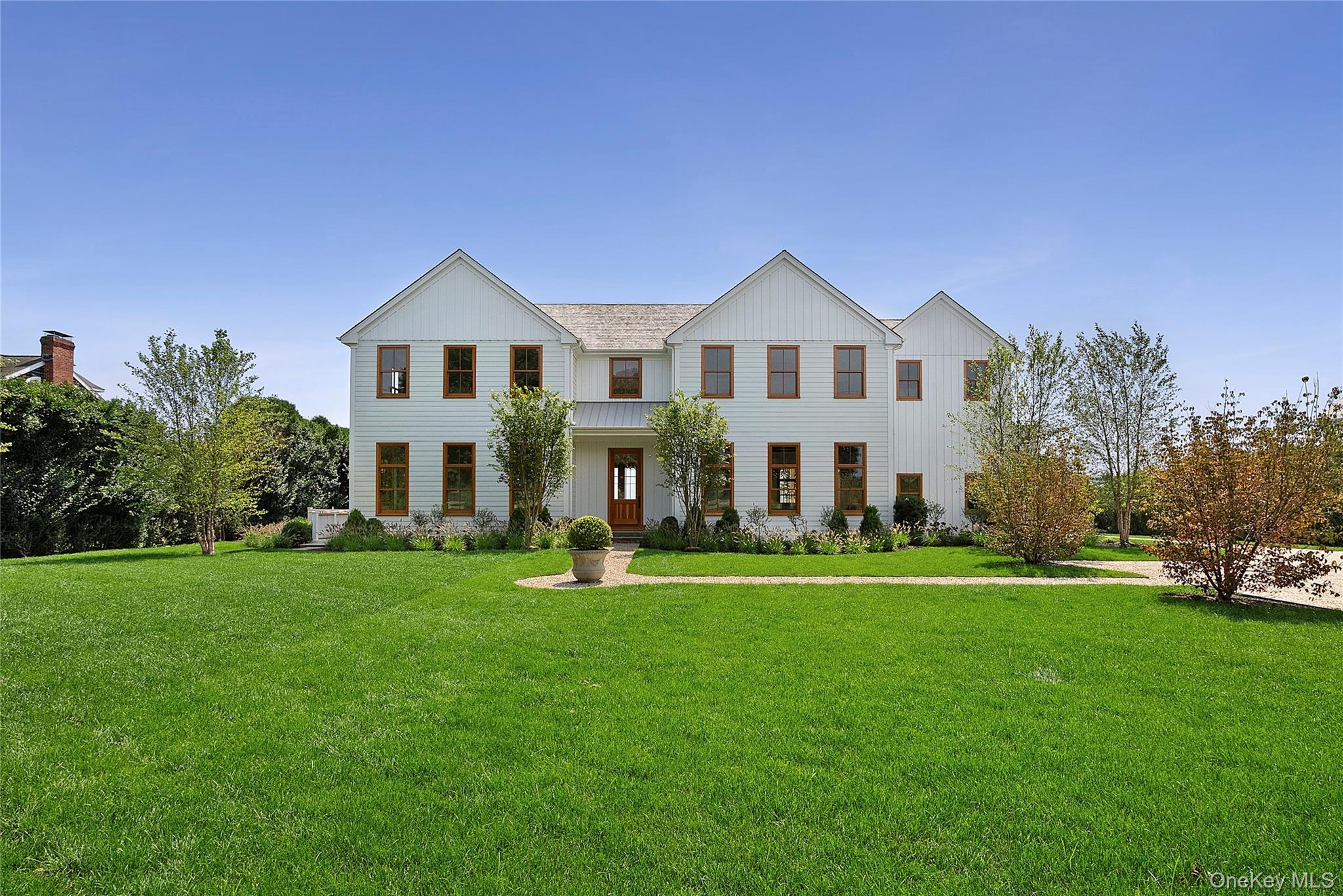 522 Wickapogue Road Southampton, NY 11968 - Photo 42 of 49 a front view of a house with a garden and trees