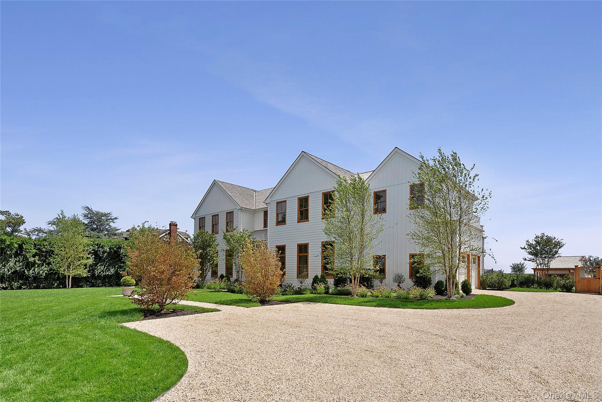 522 Wickapogue Road Southampton, NY 11968 - Photo 44 of 49 a front view of a house with a yard and garage