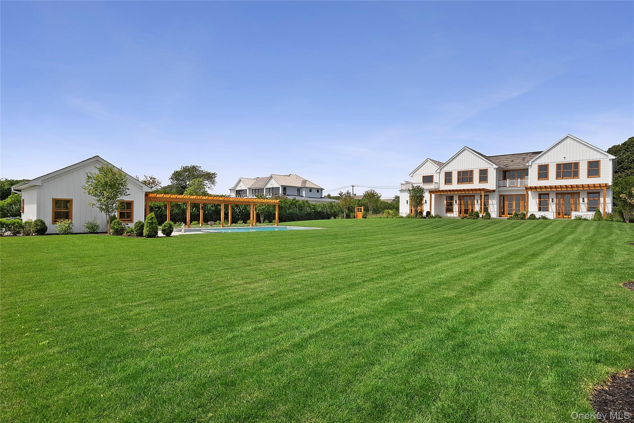 522 Wickapogue Road Southampton, NY 11968 - Photo 48 of 49 a front view of a house with a garden