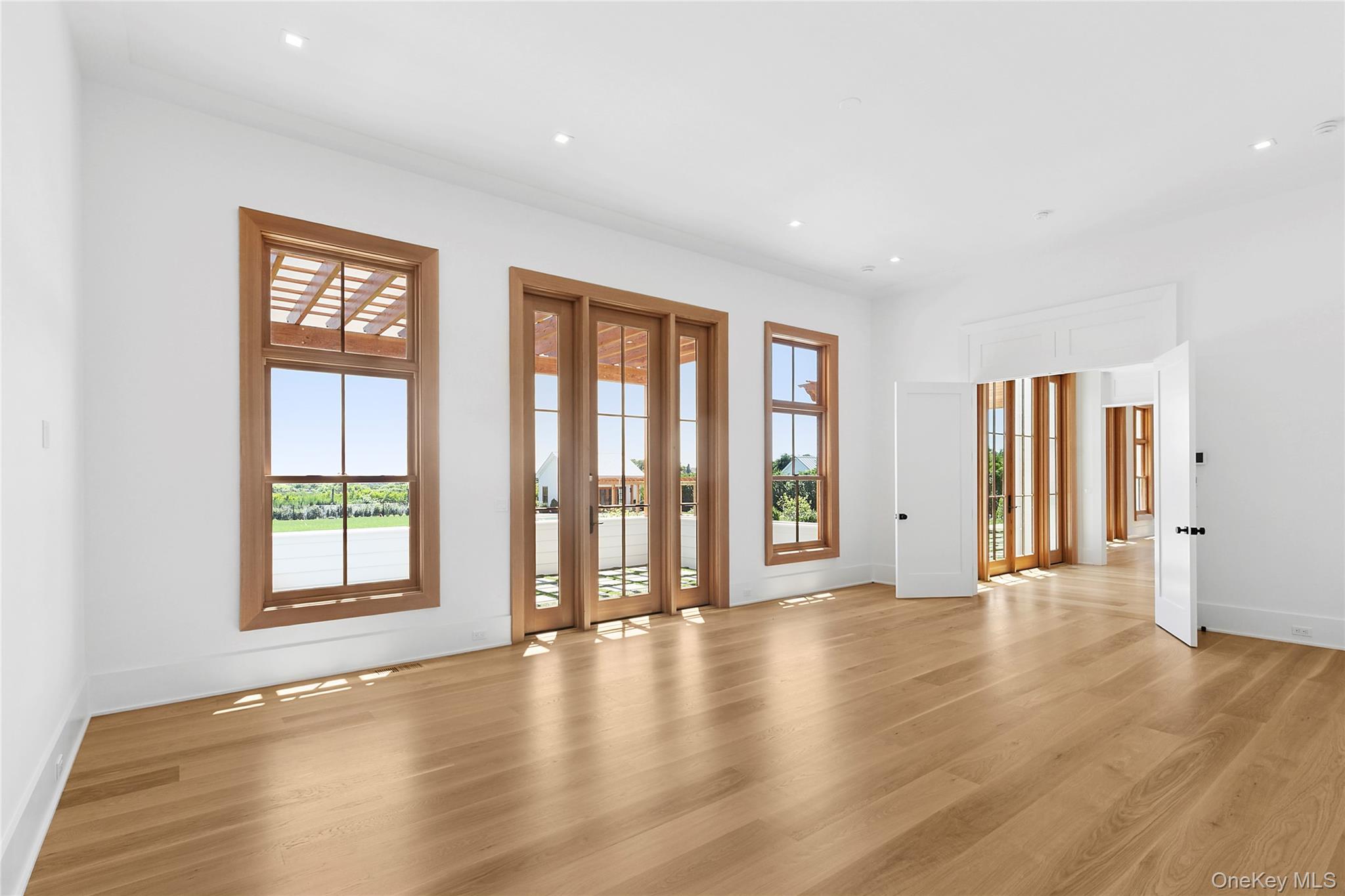 522 Wickapogue Road Southampton, NY 11968 - Photo 9 of 49 a view of an empty room with window and wooden floor