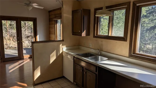 a kitchen with stainless steel appliances granite countertop a sink a refrigerator and window