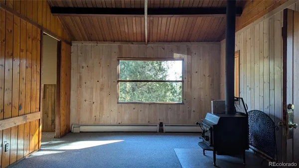 a view of a room with furniture and a window