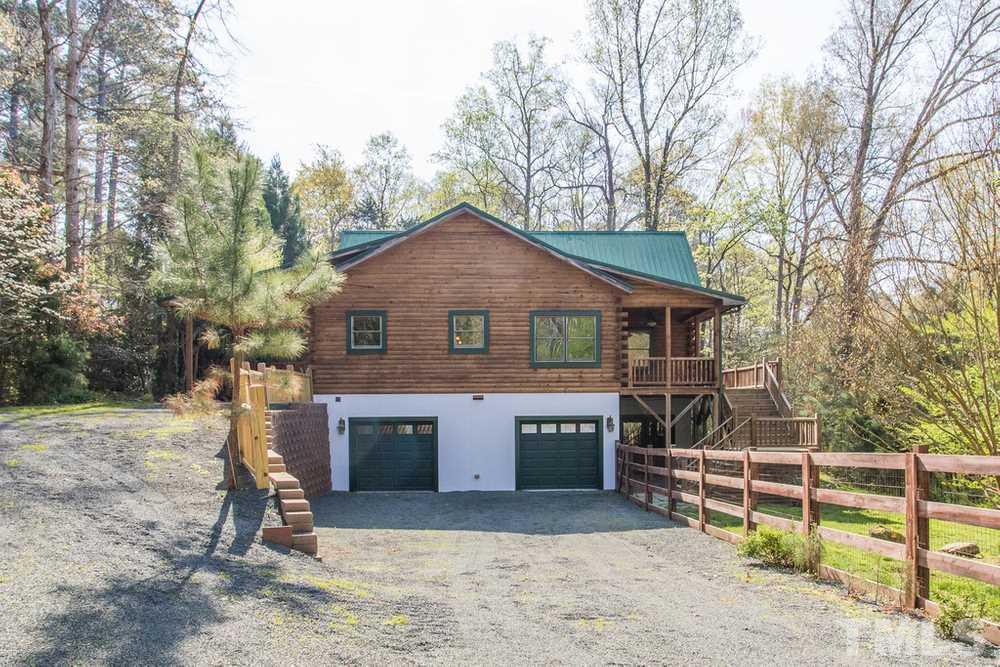 307 November Drive Durham, NC 27712 - Photo 2 of 30 a front view of a house with a yard and garage
