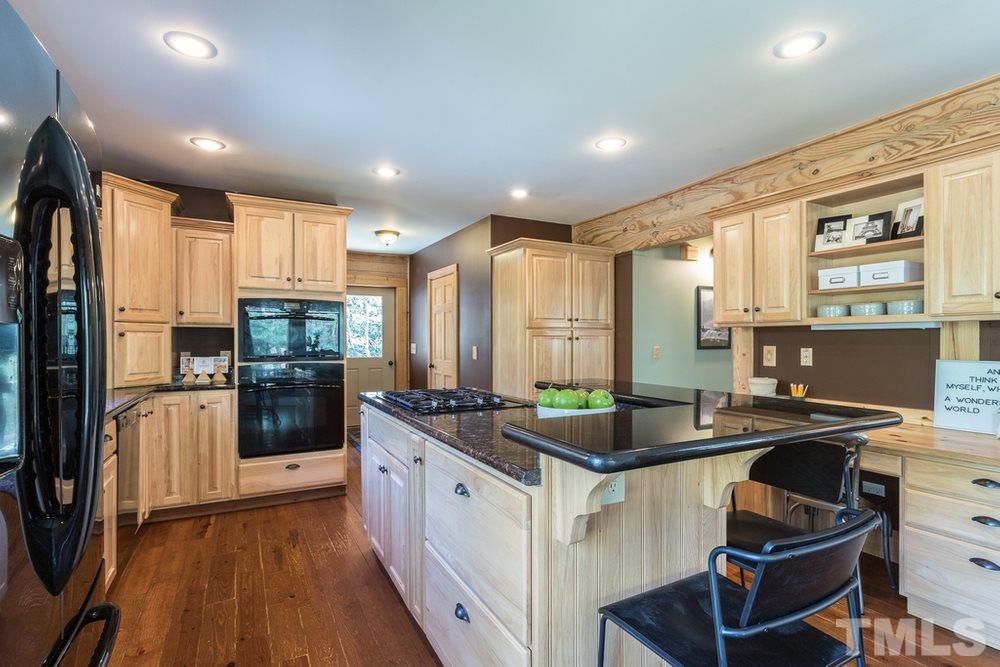 307 November Drive Durham, NC 27712 - Photo 15 of 30 a kitchen with stainless steel appliances granite countertop a sink stove and refrigerator