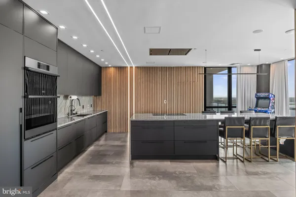 a living room with furniture and floor to ceiling windows
