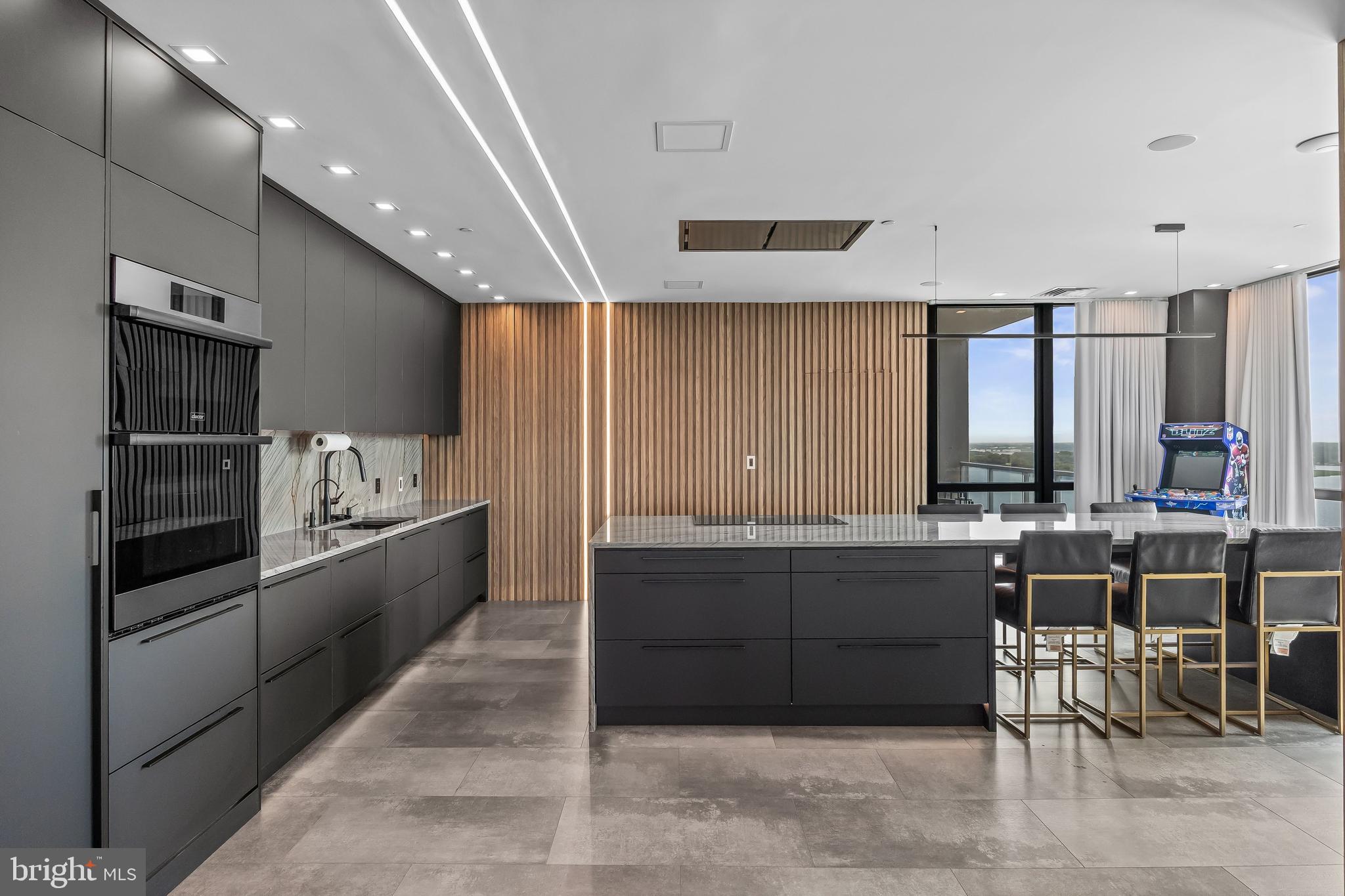 901 North Penn Street, Unit P24012 Philadelphia, PA 19123 - Photo 13 of 59 a large white kitchen with a large window and stainless steel appliances