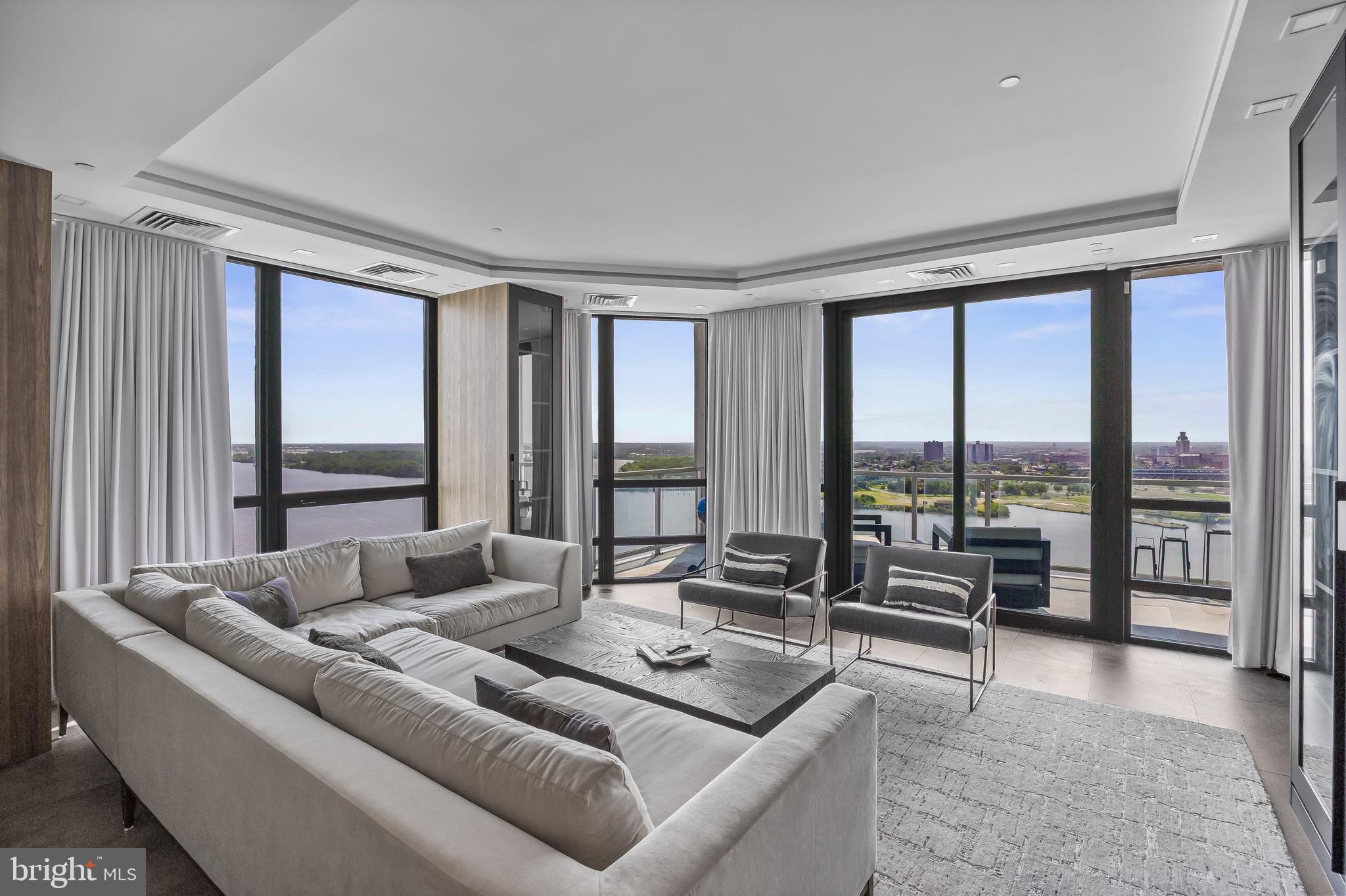901 North Penn Street, Unit P24012 Philadelphia, PA 19123 - Photo 17 of 59 a living room with furniture and floor to ceiling windows
