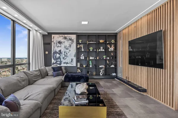 a living room with furniture and large windows